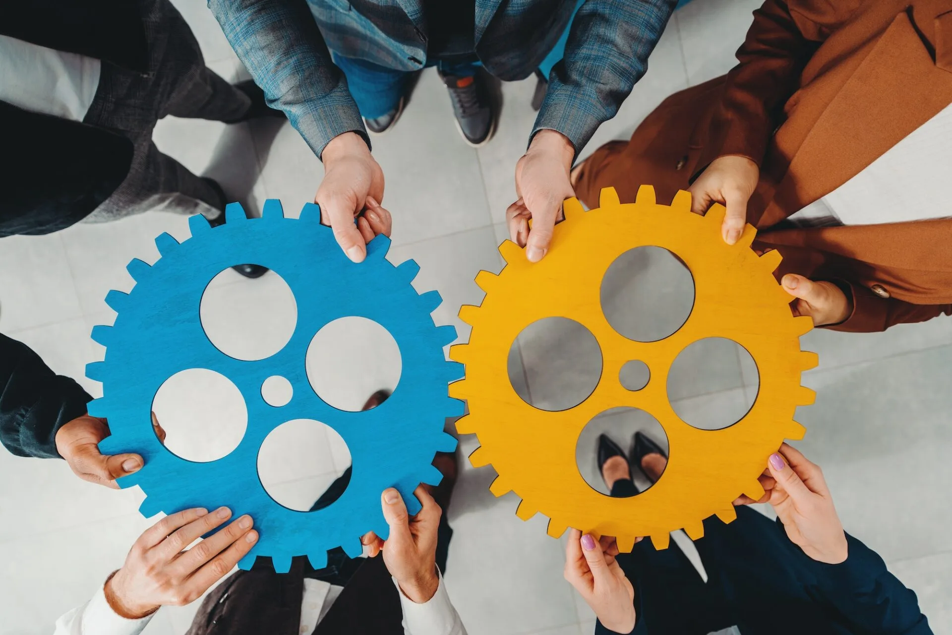 Business team connect pieces of gears like a teamwork and partners