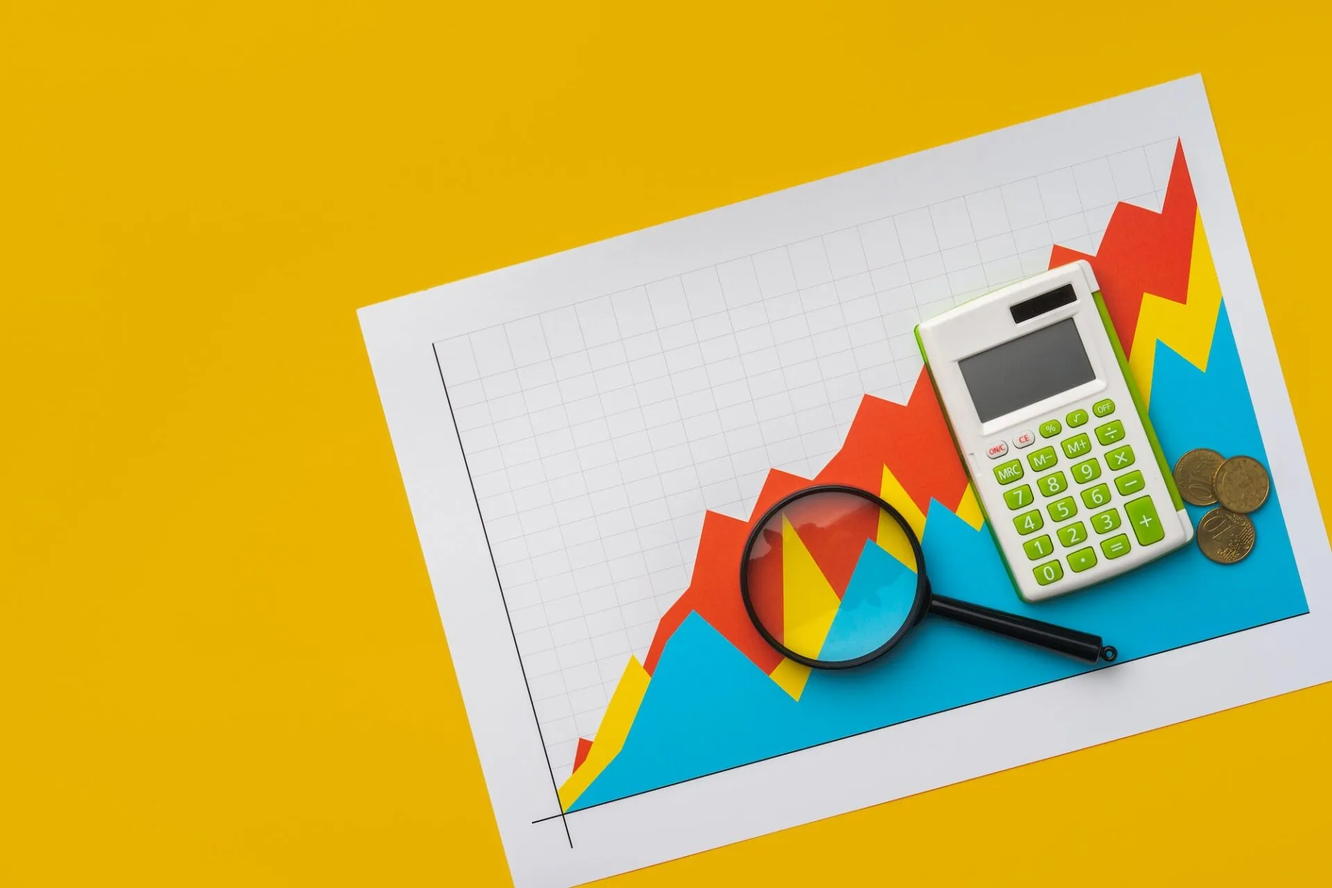 Business graphs paper and calculator on table