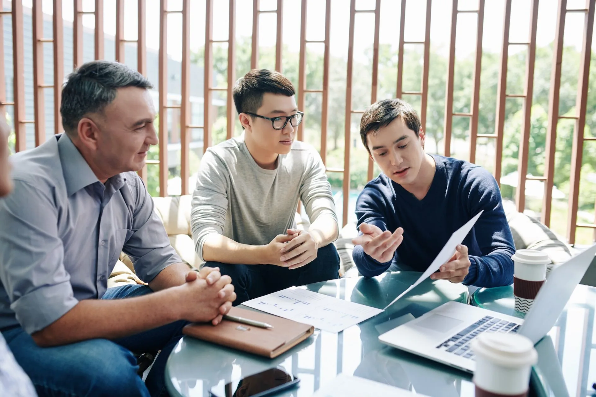 Manager showing report to colleagues