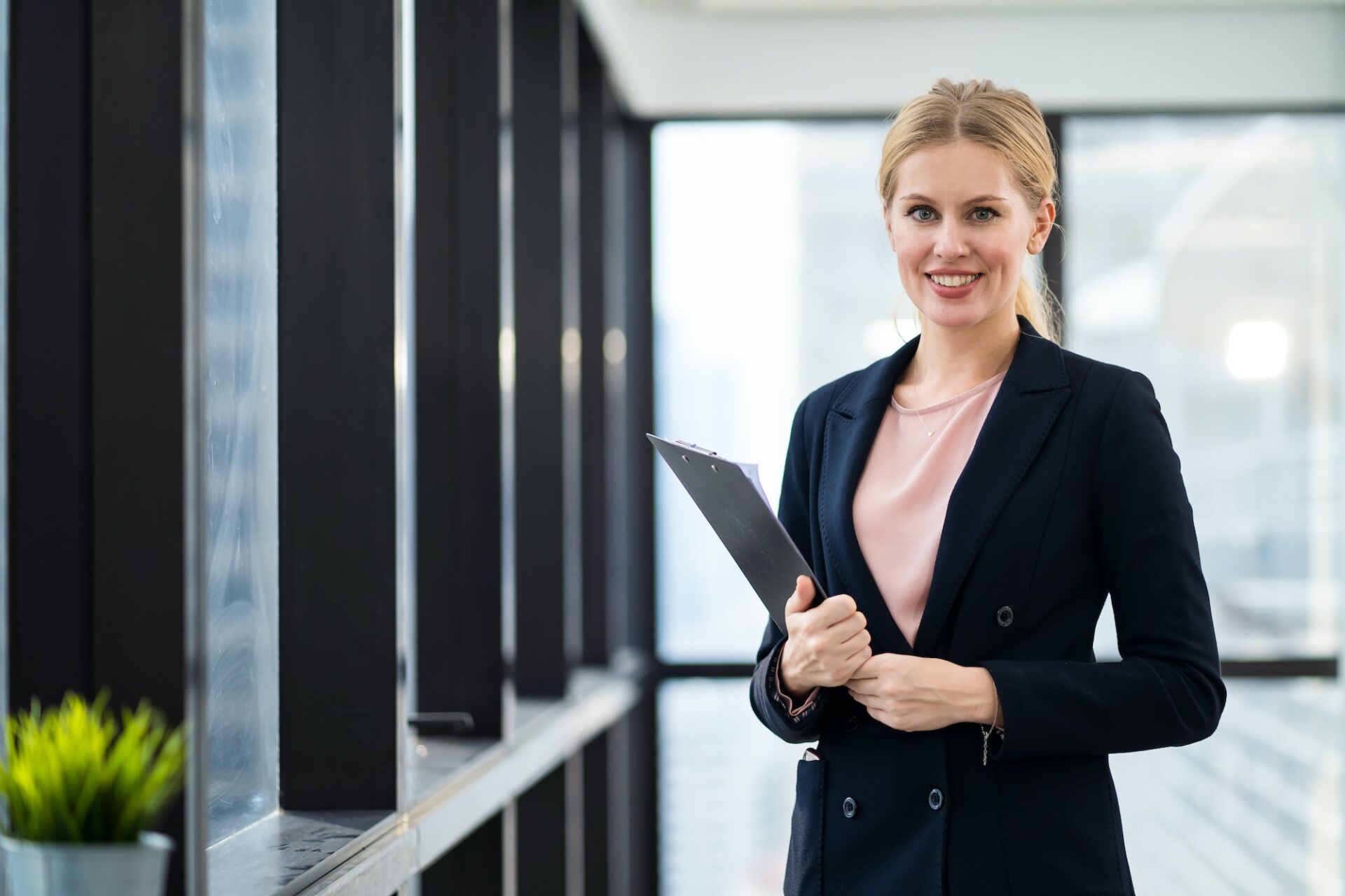 Caucasian young woman hold clipboard for meeting standing in working place, office.