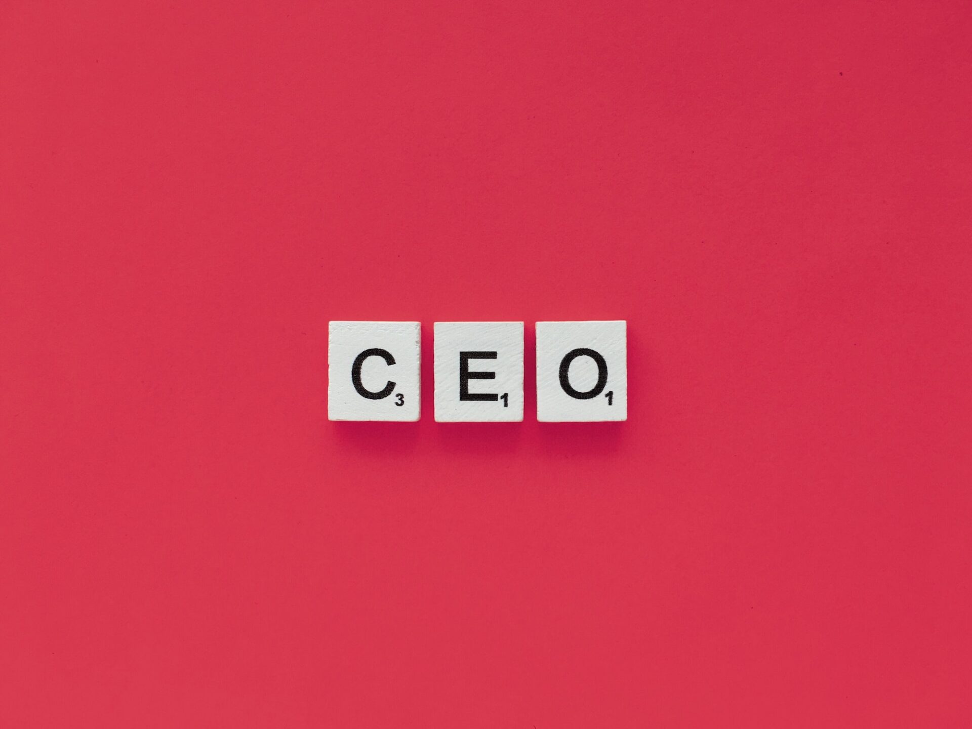CEO scrabble letters word on a pink background