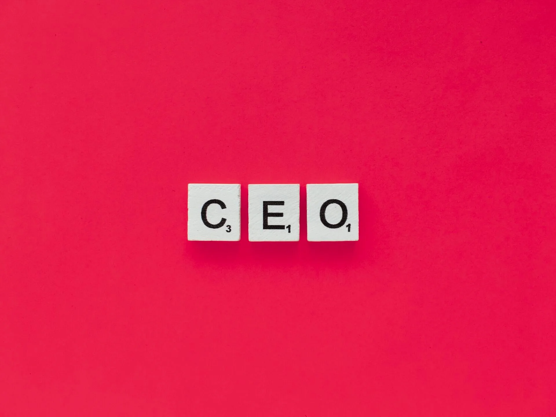 CEO scrabble letters word on a pink background