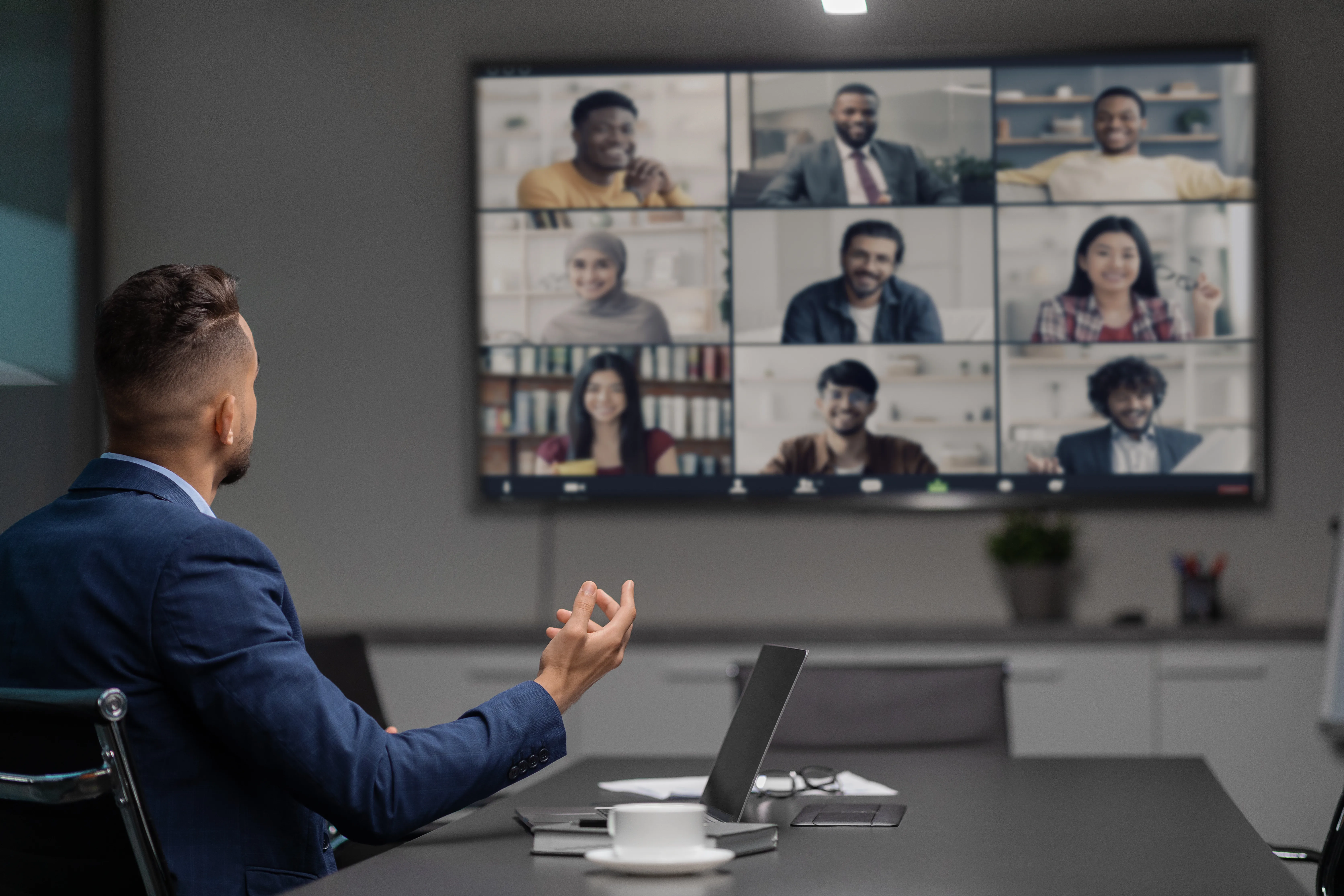 Arabic CEO having video conference with his team, office interior