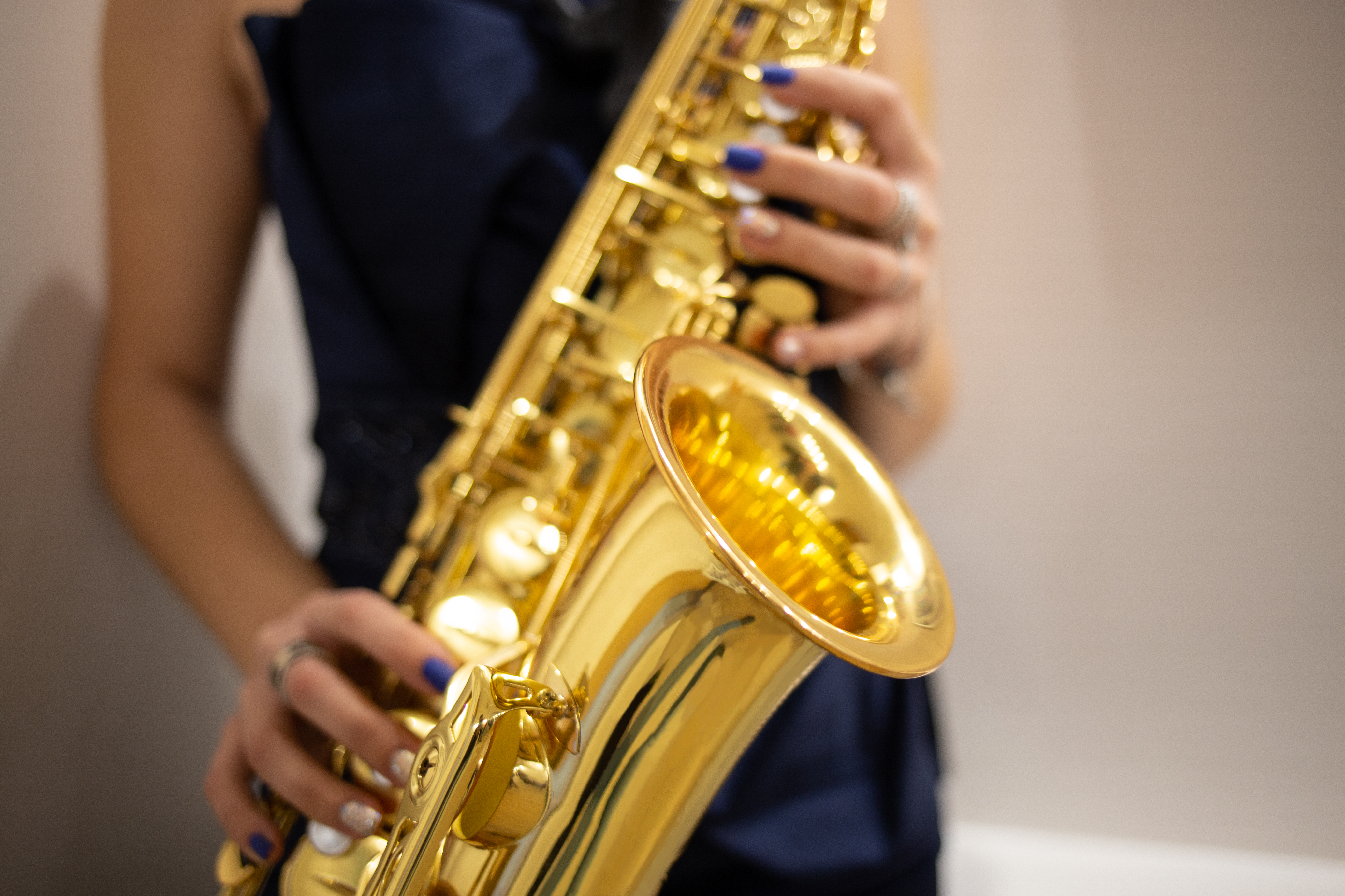 Young woman jazz musician playing the saxophone, closeup image