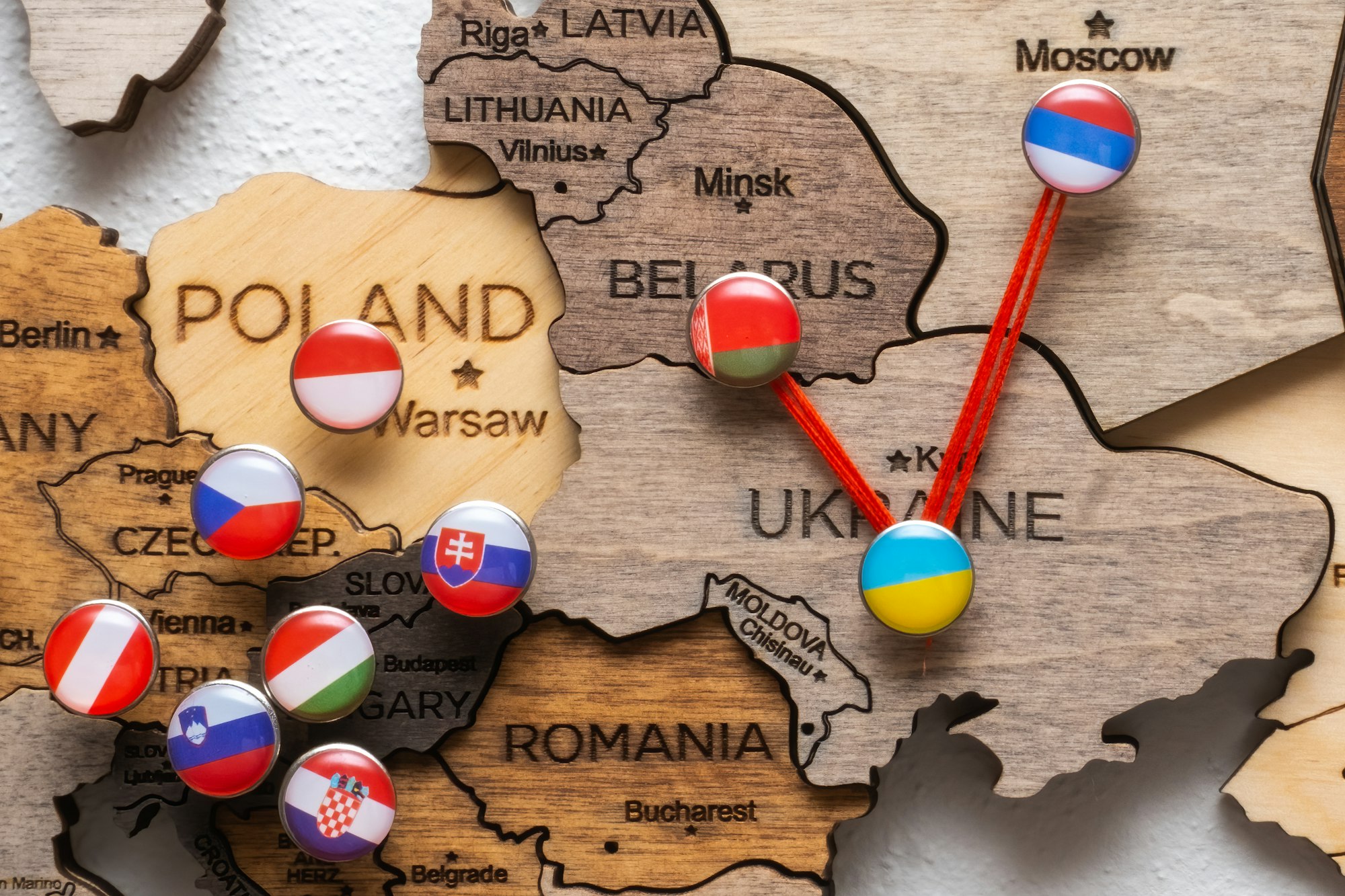 Pins with flags and threads on the wooden maps demonstrate Russia and Belarus aggression in Ukraine