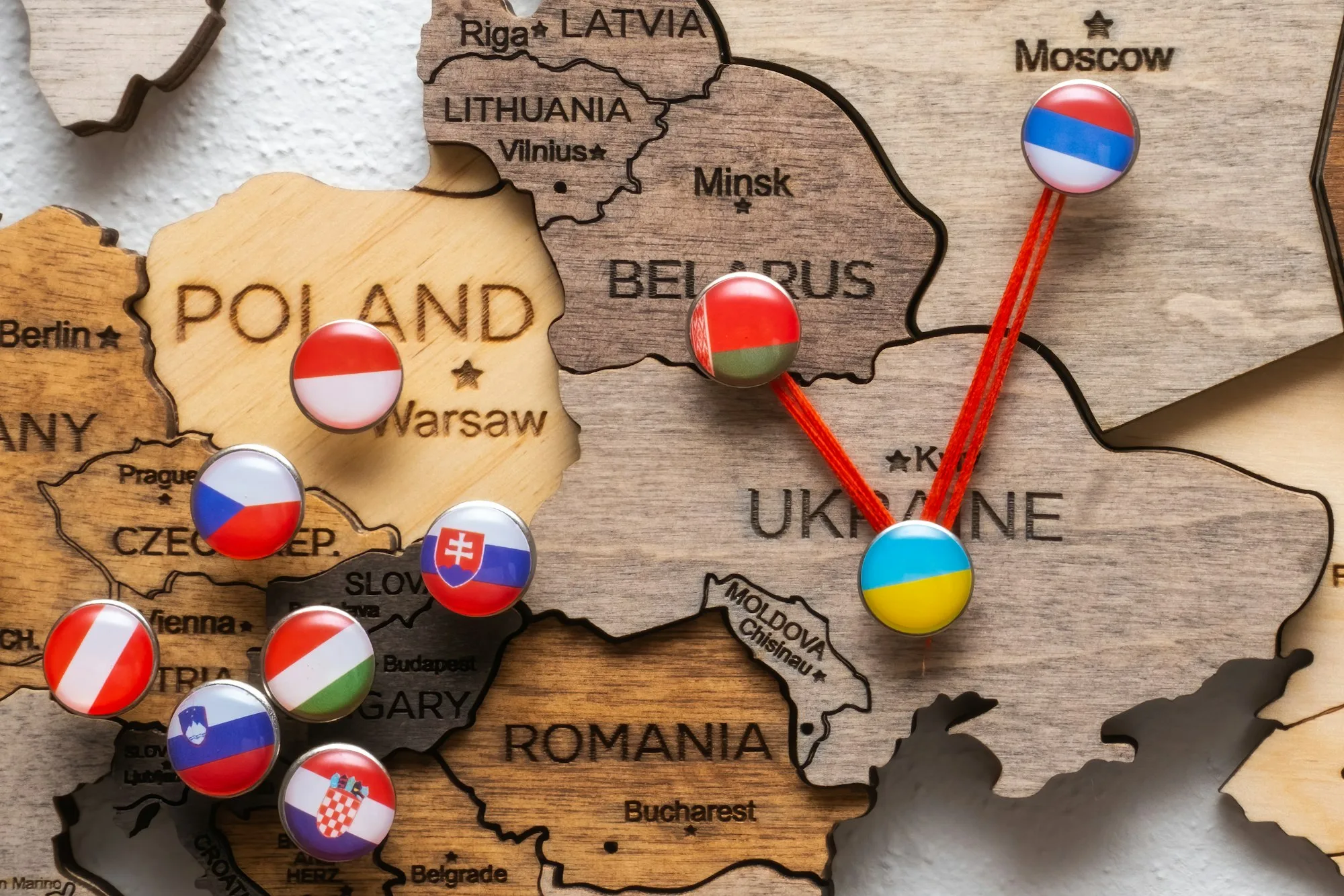 Pins with flags and threads on the wooden maps demonstrate Russia and Belarus aggression in Ukraine